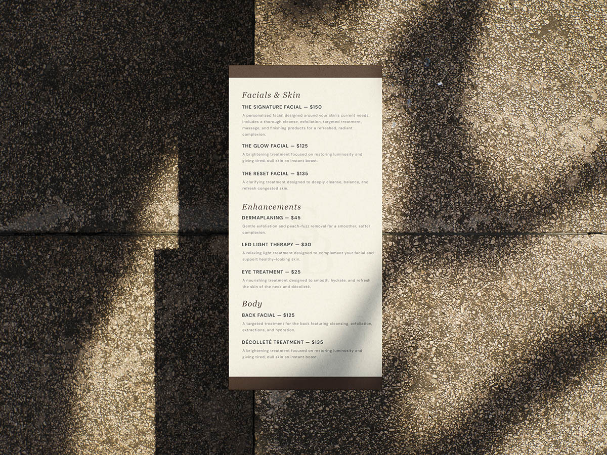 A menu for Lisa Smith Beauty laying on concrete.