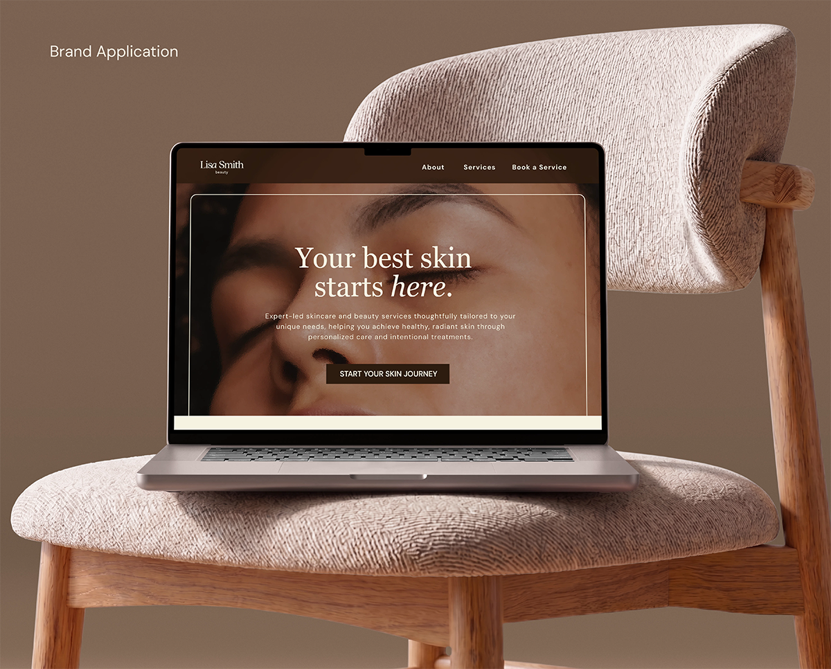 A laptop showing Lisa Smith Beauty's homepage sits on chair.