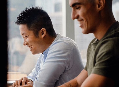 Two men smiling