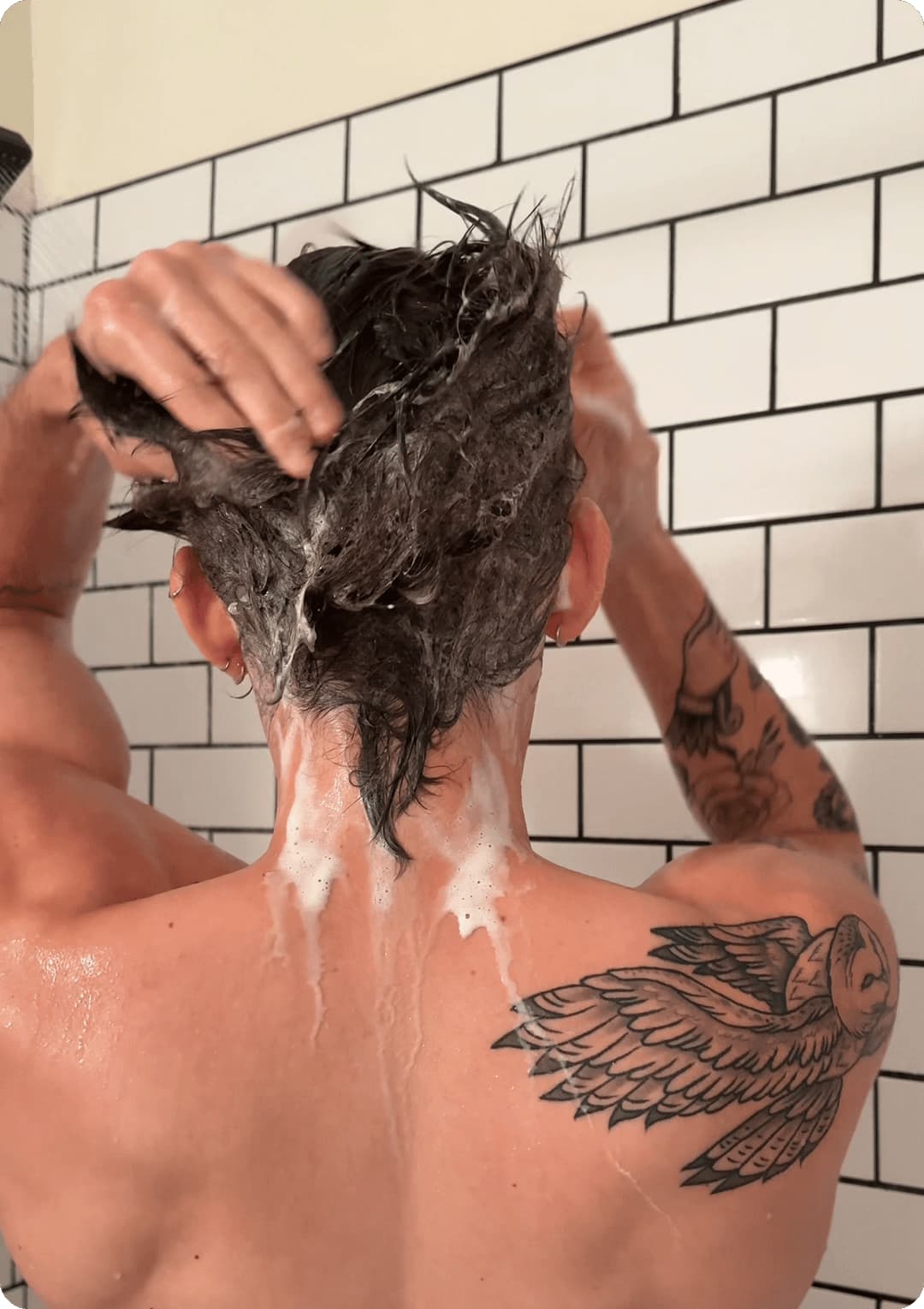 man washing his hair in shower