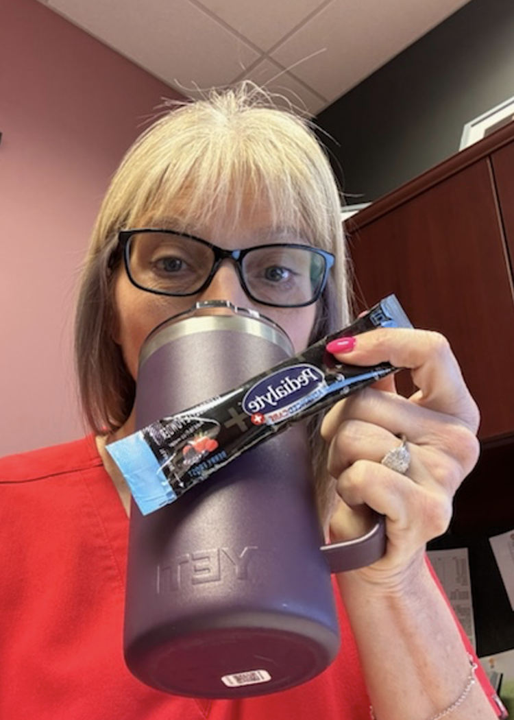 woman drinking pedialyte