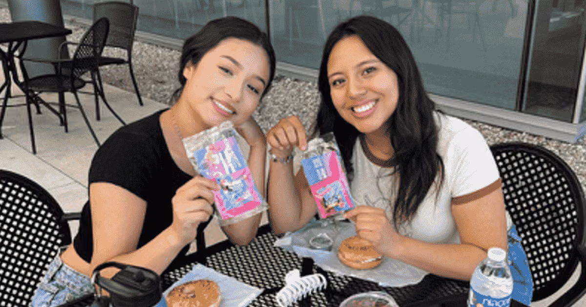 two woman holding samples