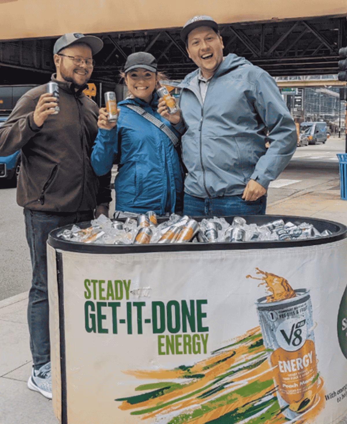 people posing holding V8 product samples