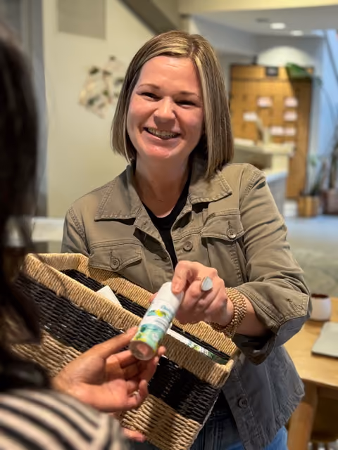 woman giving out batiste sample
