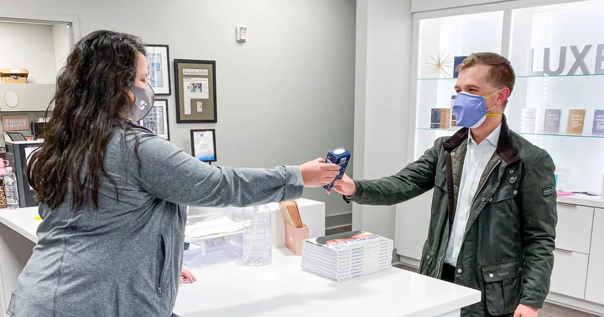 woman handing out product samples 