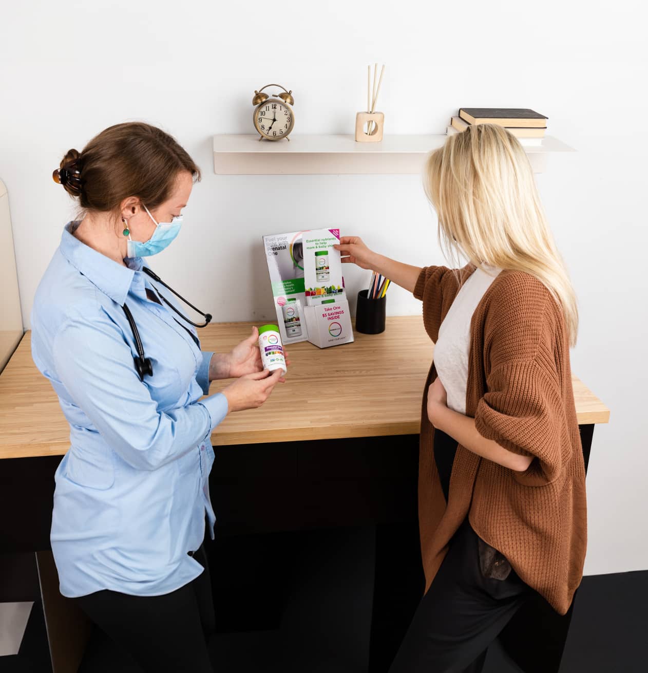 two woman holding samples and flyers