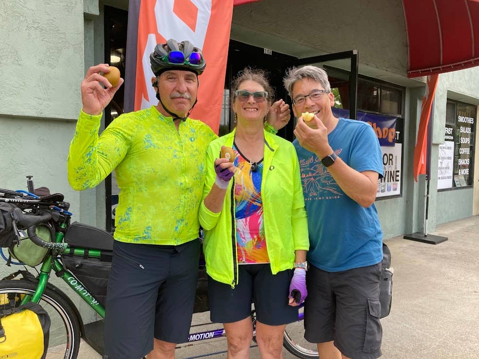 three people holding zespri kiwi samples