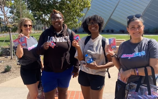 people holding sweetarts samples
