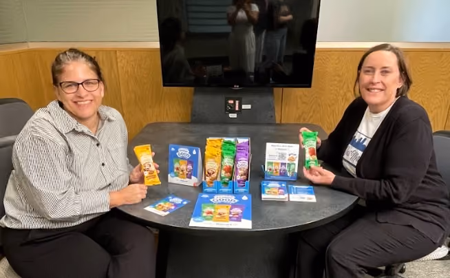 two woman holding proper good samples