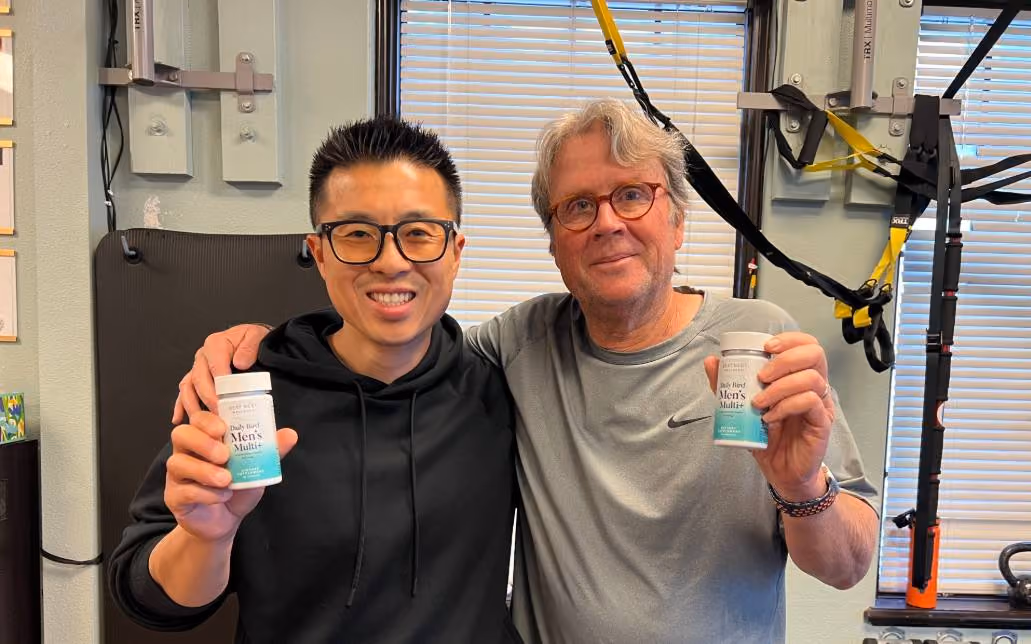 two men posing with mama bird samples