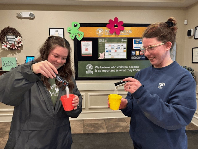 two women pouring pedialyte into a drinking water