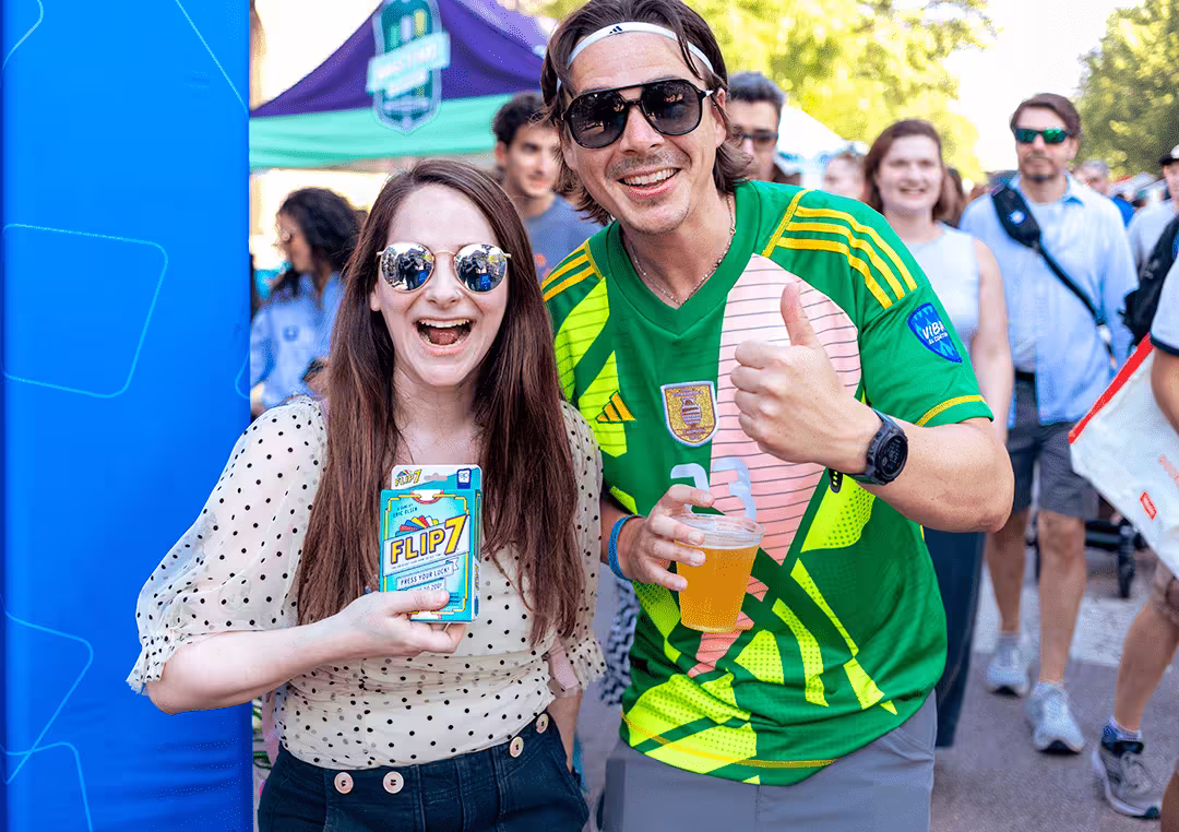 man and woman holding flip 7 game