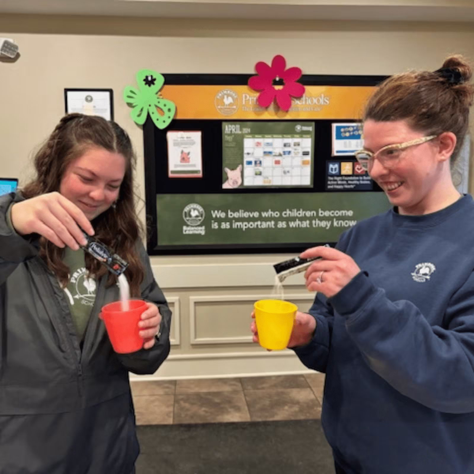 two women pouring pedialyte into a cup