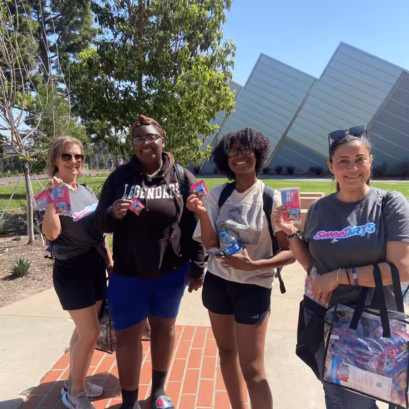 four women holding sweetarts samples