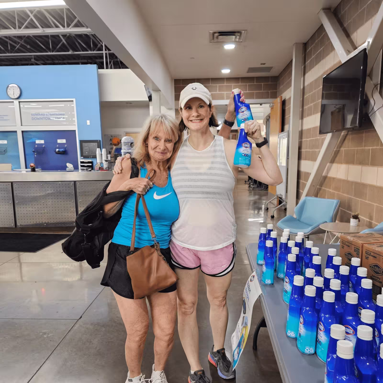 two women holding clorox samples