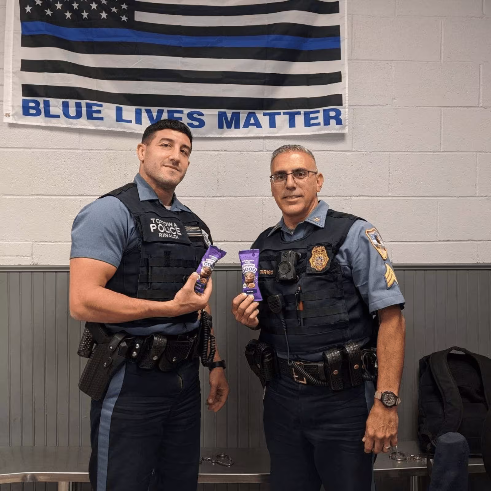 two policemen holding proper good samples