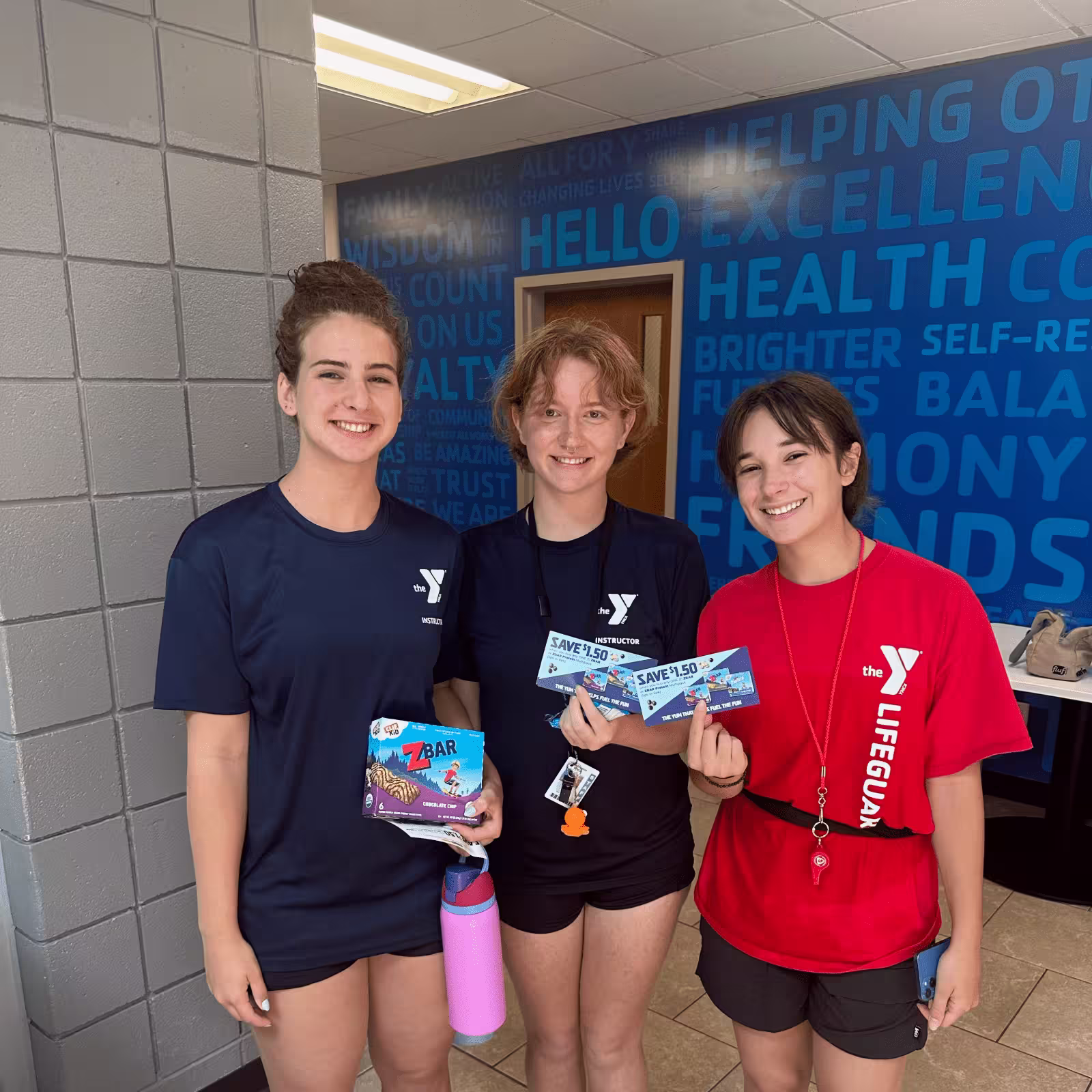 three women holding CLIF zbar samples