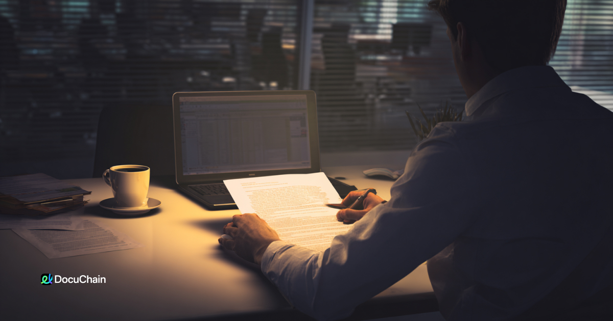 Professional signs digital document late at night in office, representing 24/7 access to online signatures with cloud-based DocuChain platform