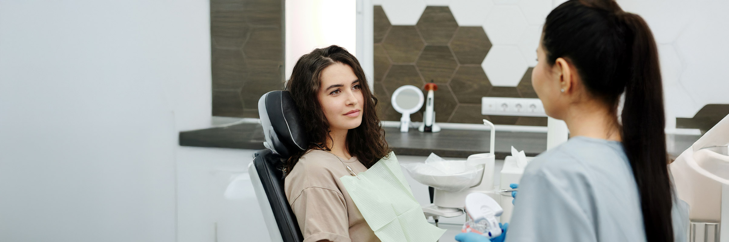 Woman at dental clinic asking about pricing options.