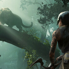 A close-up of Lara Croft's face, covered in dirt and sweat, looking up with a determined expression.