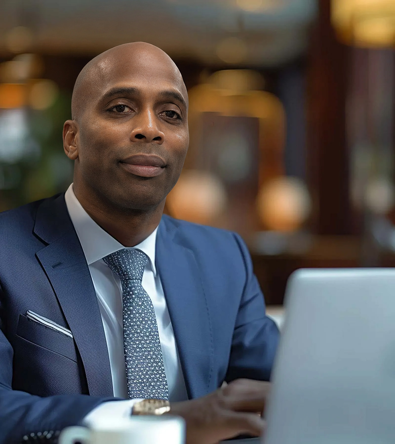 A businessman in a suit using a computer representing the Commons Capital wealth advisory team.