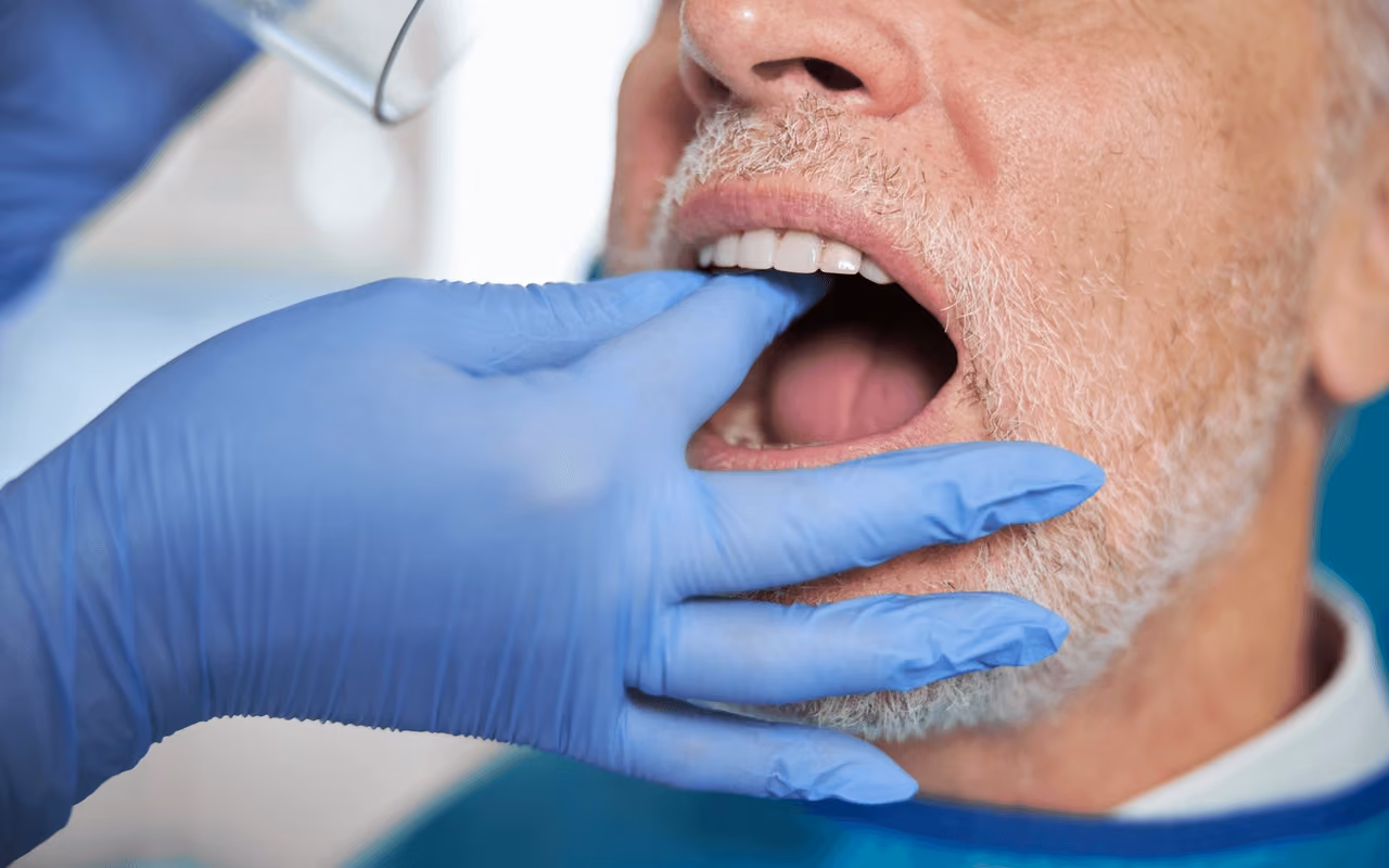 Dentist examining a patient’s teeth during consultation for full mouth reconstruction by the best dentist in Los Gatos, CA.