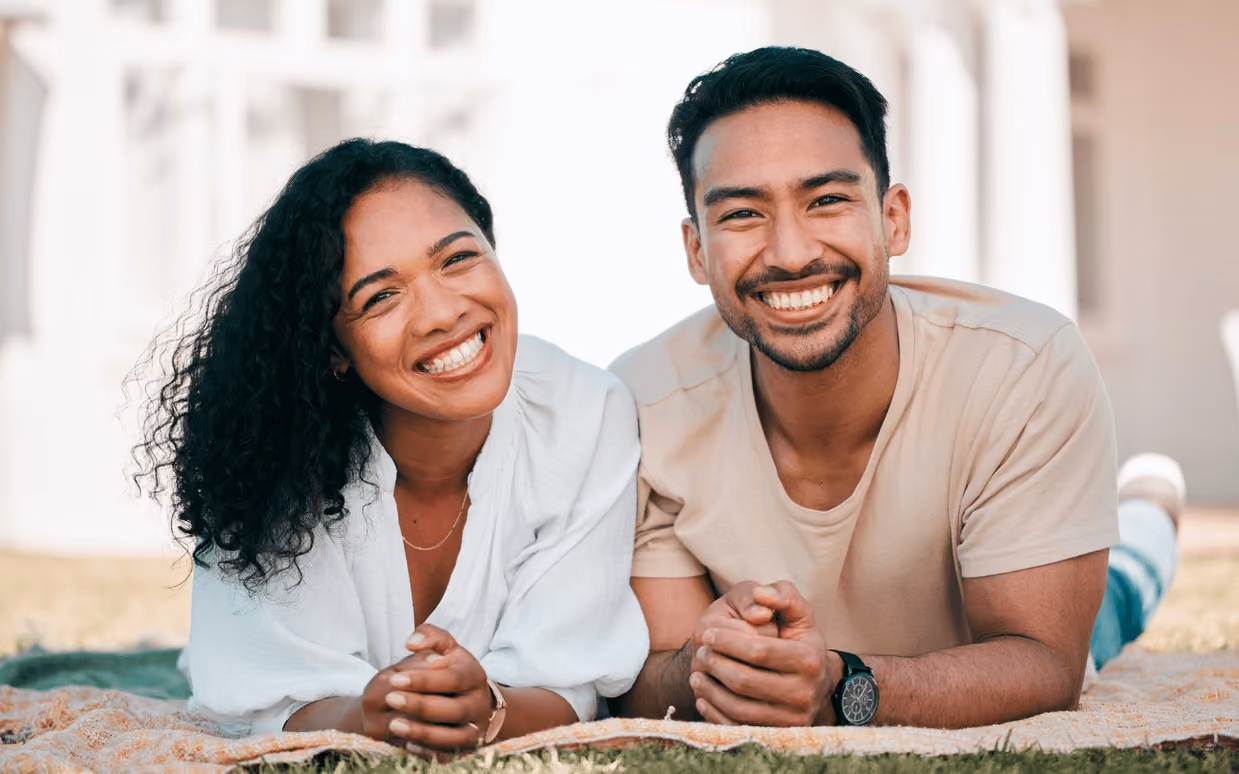 Couple smiling outdoors after a smile makeover, showcasing results achievable with the best cosmetic dentist in Los Gatos.