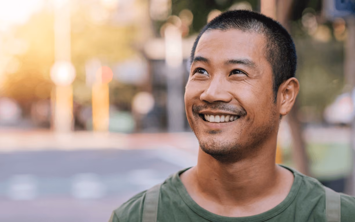 Man smiling outdoors with a confident, healthy smile, highlighting results you can achieve with care from the best cosmetic dentist in Los Gatos.