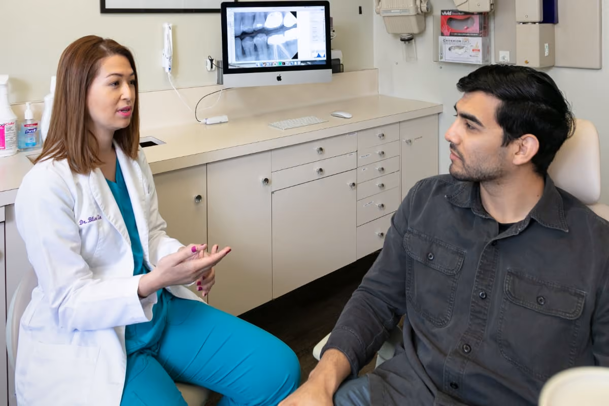 Dr. Zin discusses dental X-rays with a patient to determine when it is time to replace a filling at the best dentist in Los Gatos, CA.