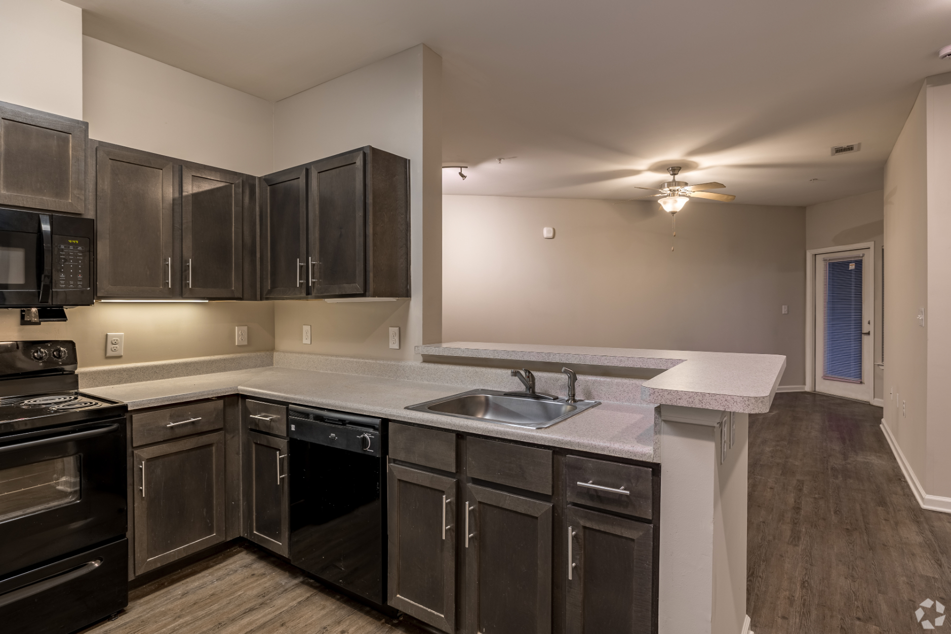 Kitchen with brown cabinets and black appliances