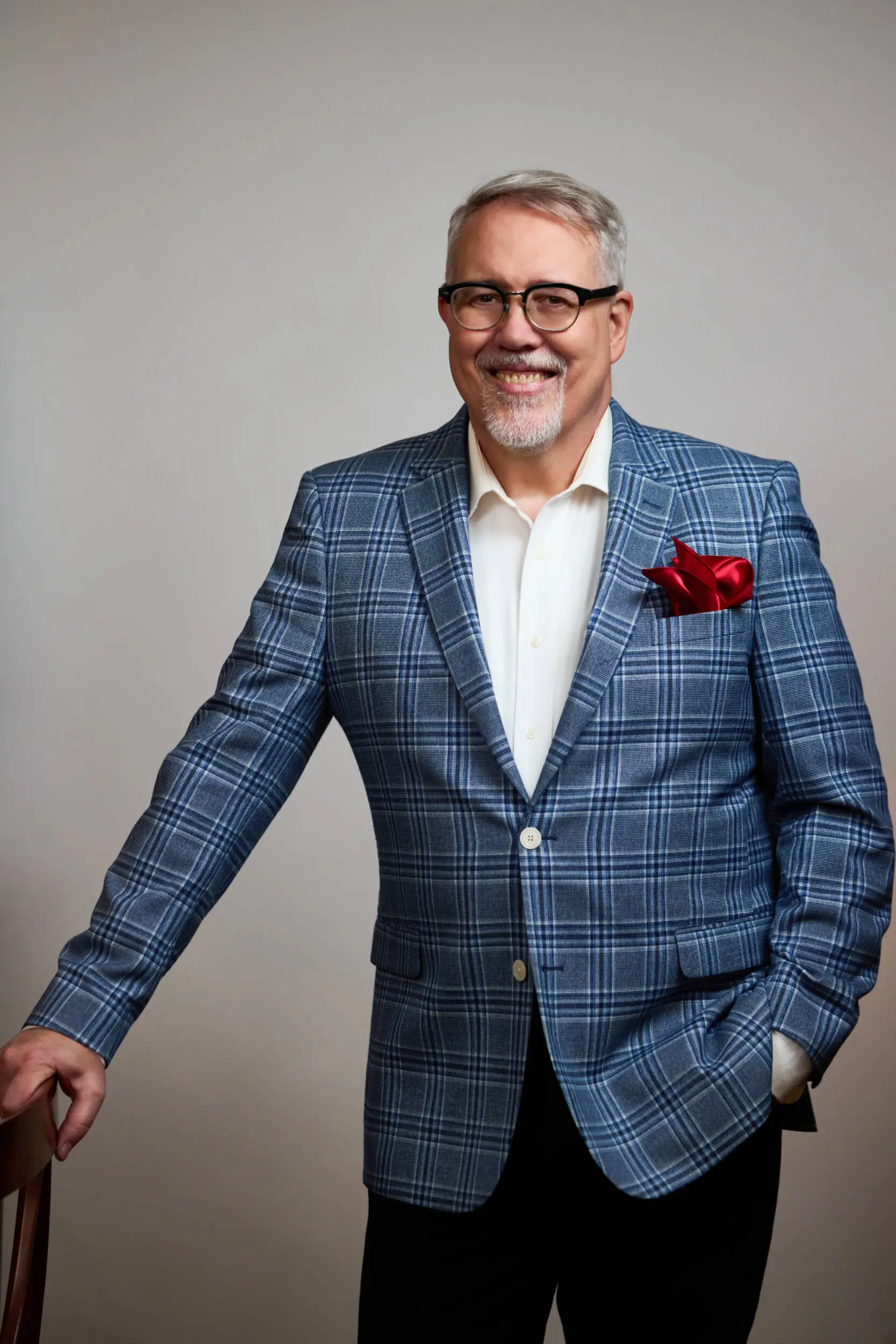 David Chase portrait - standing next to chair