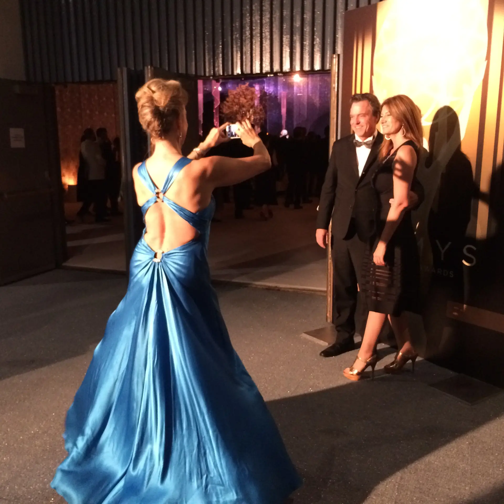 Paula takes a photo of Derek McLane and Lia Vollack at the Emmys