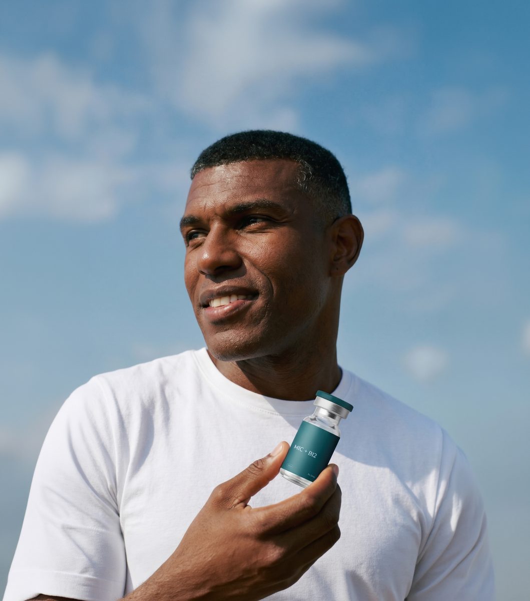 Man holding a MIC + B12 vial