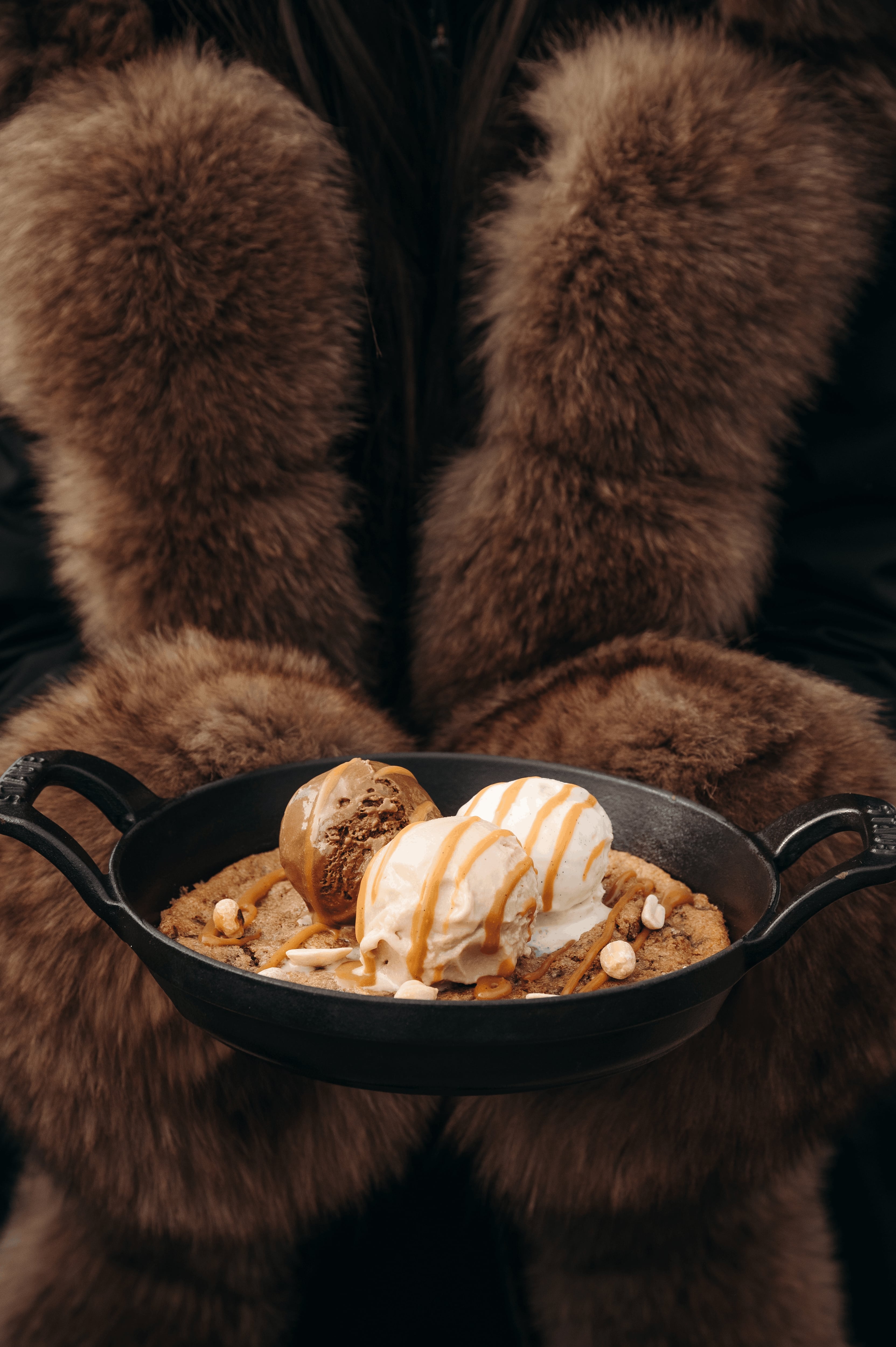 Giant cookie dessert with caramel and peanuts, vanilla and chocolate ice cream by Eric Fréchon Chalet Sauvage restaurant in Megève