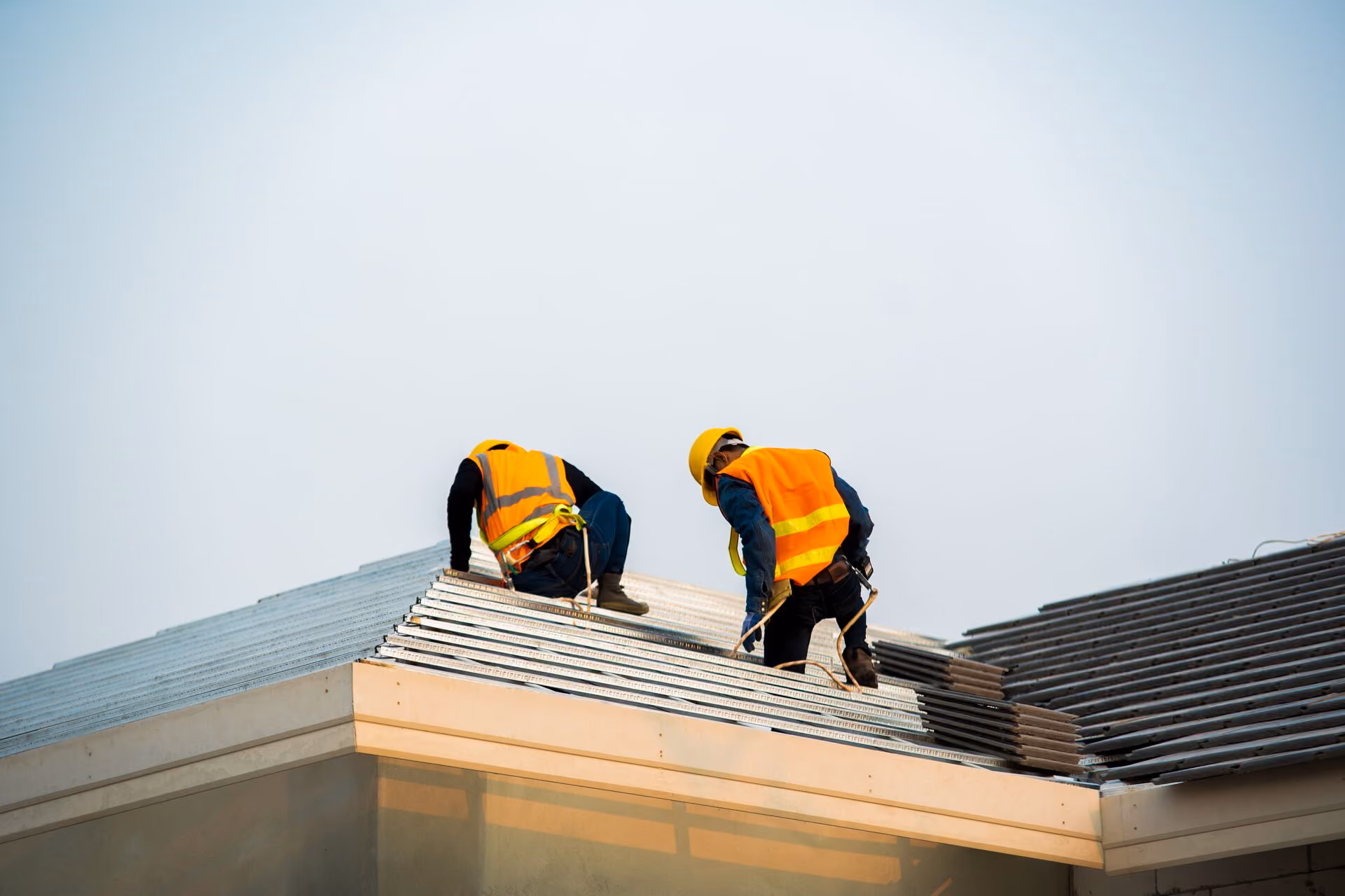 Roofing crew installing commercial roof panels