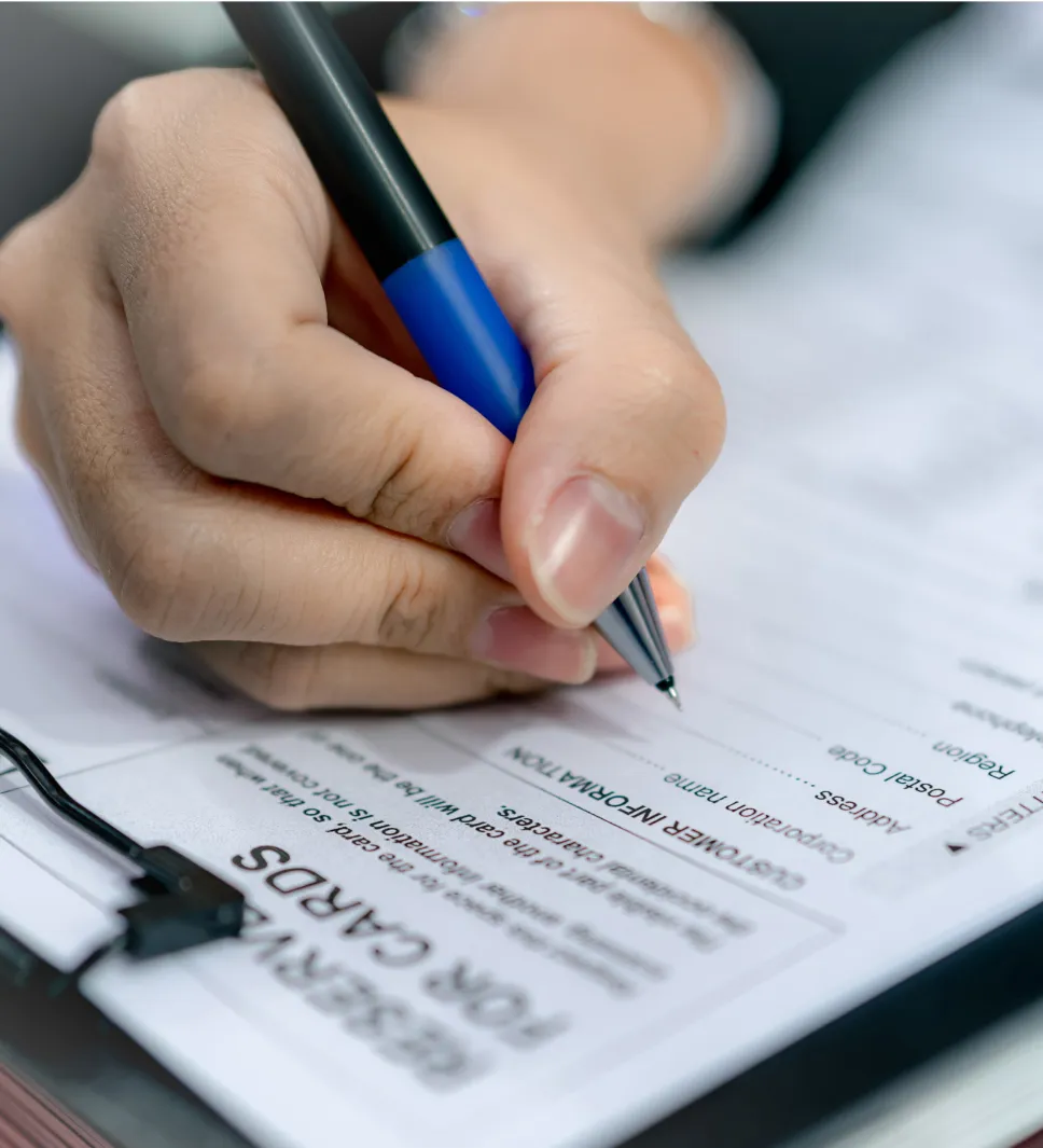 A hand writing on a piece of paper