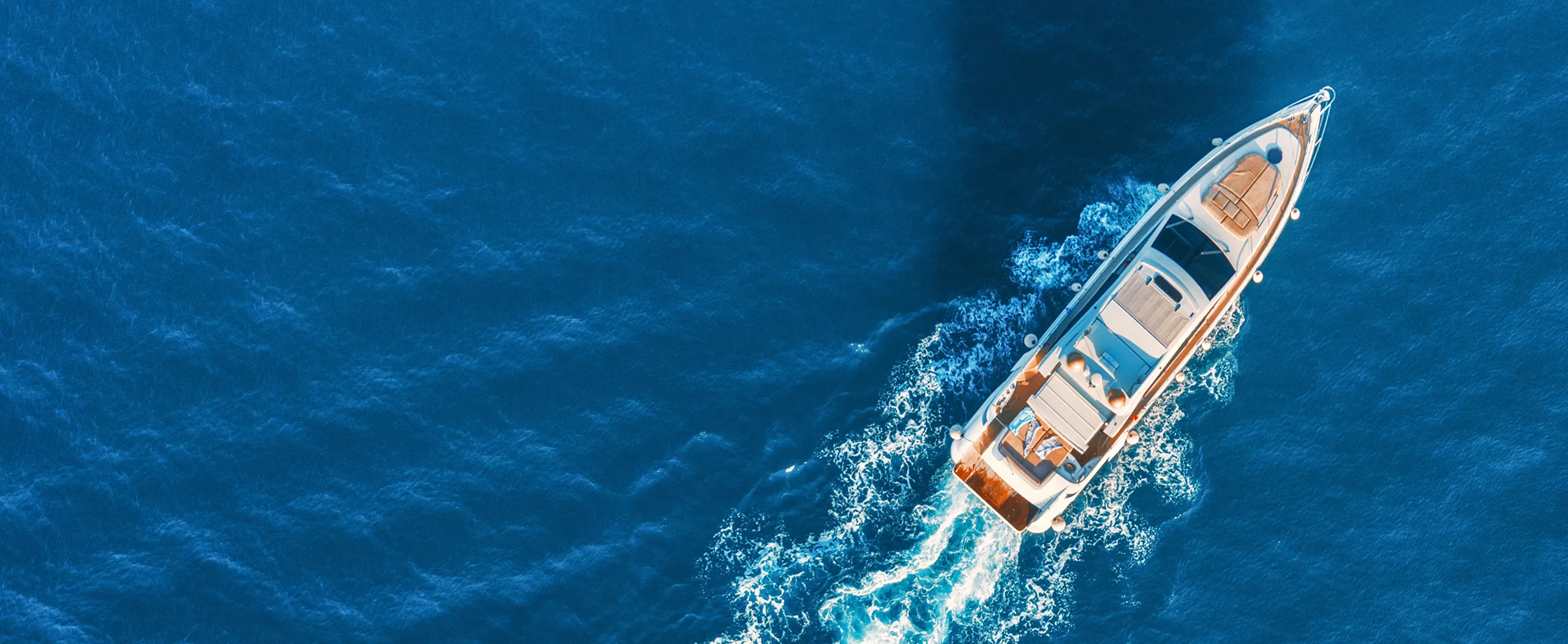 A boat in the water, cruising