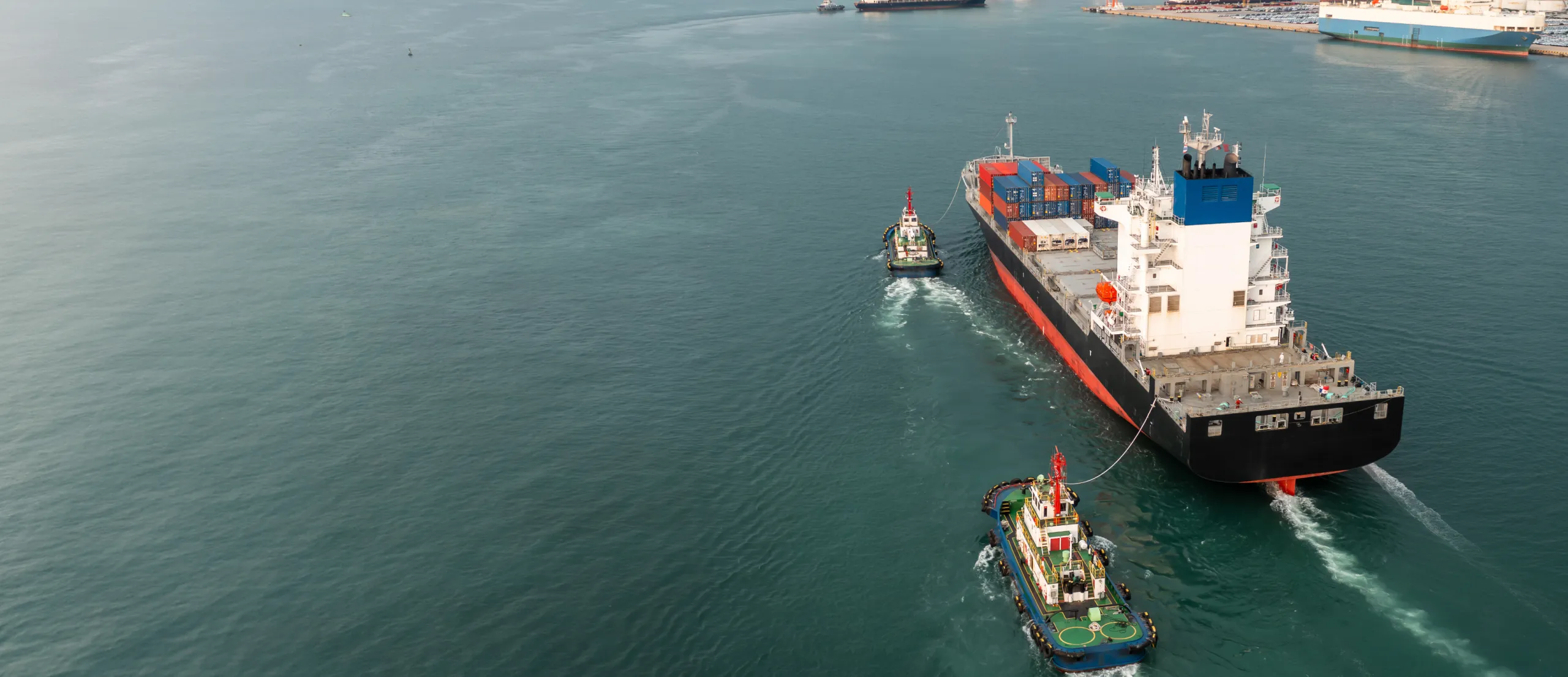 One large vessel and two smaller ones cruising in the water