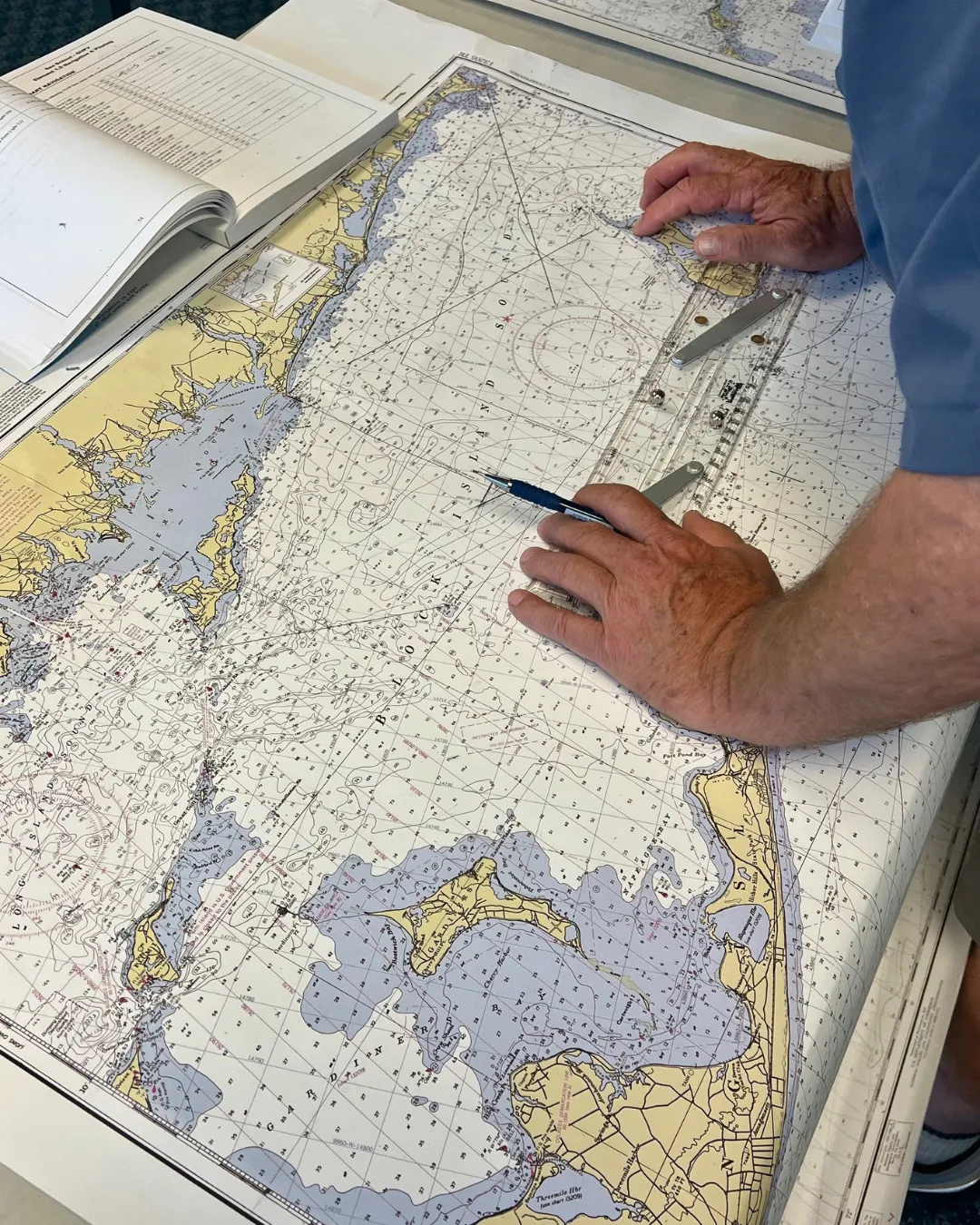 Person's hands on a map measuring something