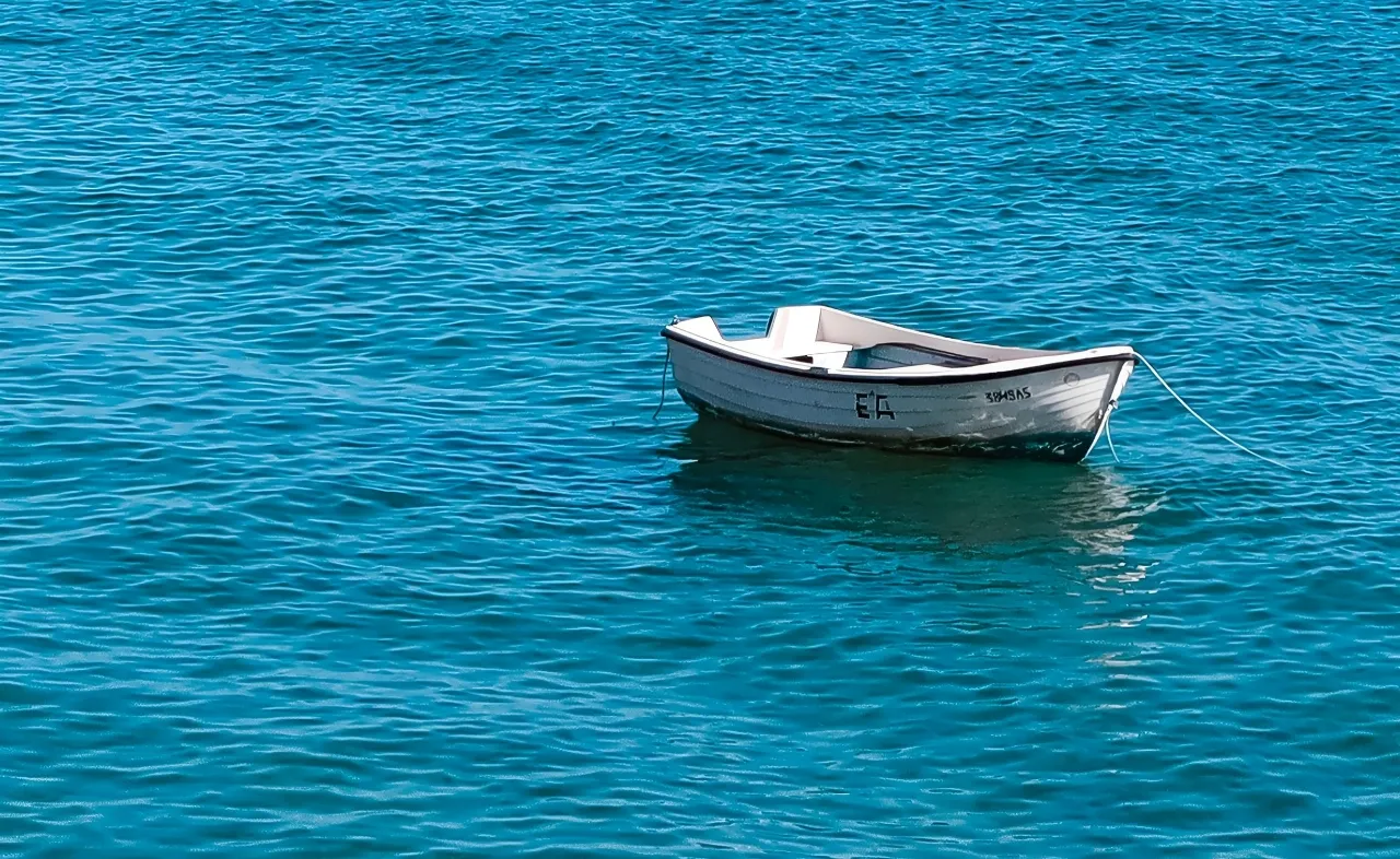 A small boat drifted away in the ocean