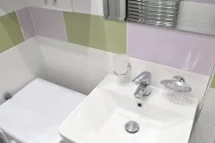 Detail umyvadla s jemně barevnými kachličkami