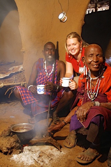 Maasai host serving chai inside a boma