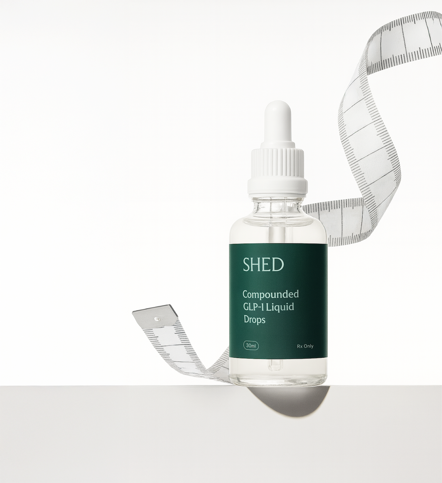 Bottle labeled "Shed Compounded GLP-1 Liquid Drops" with flexible measuring tape twirling around in the background