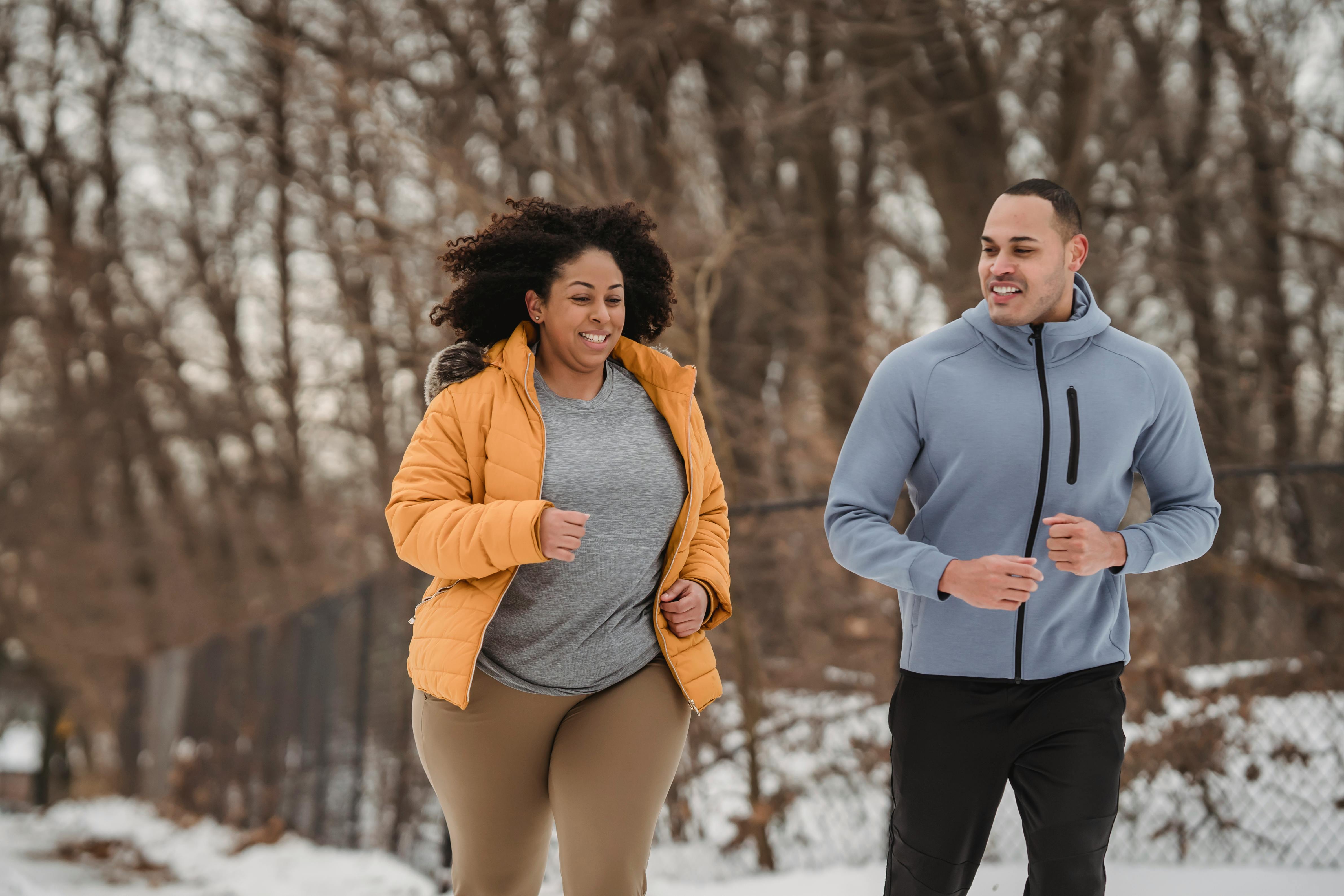 Woman and man going for a jog in winter