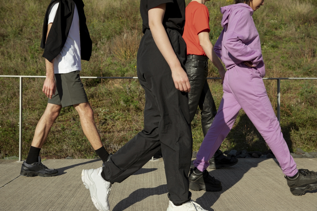 4 people in workout clothes walking outdoors