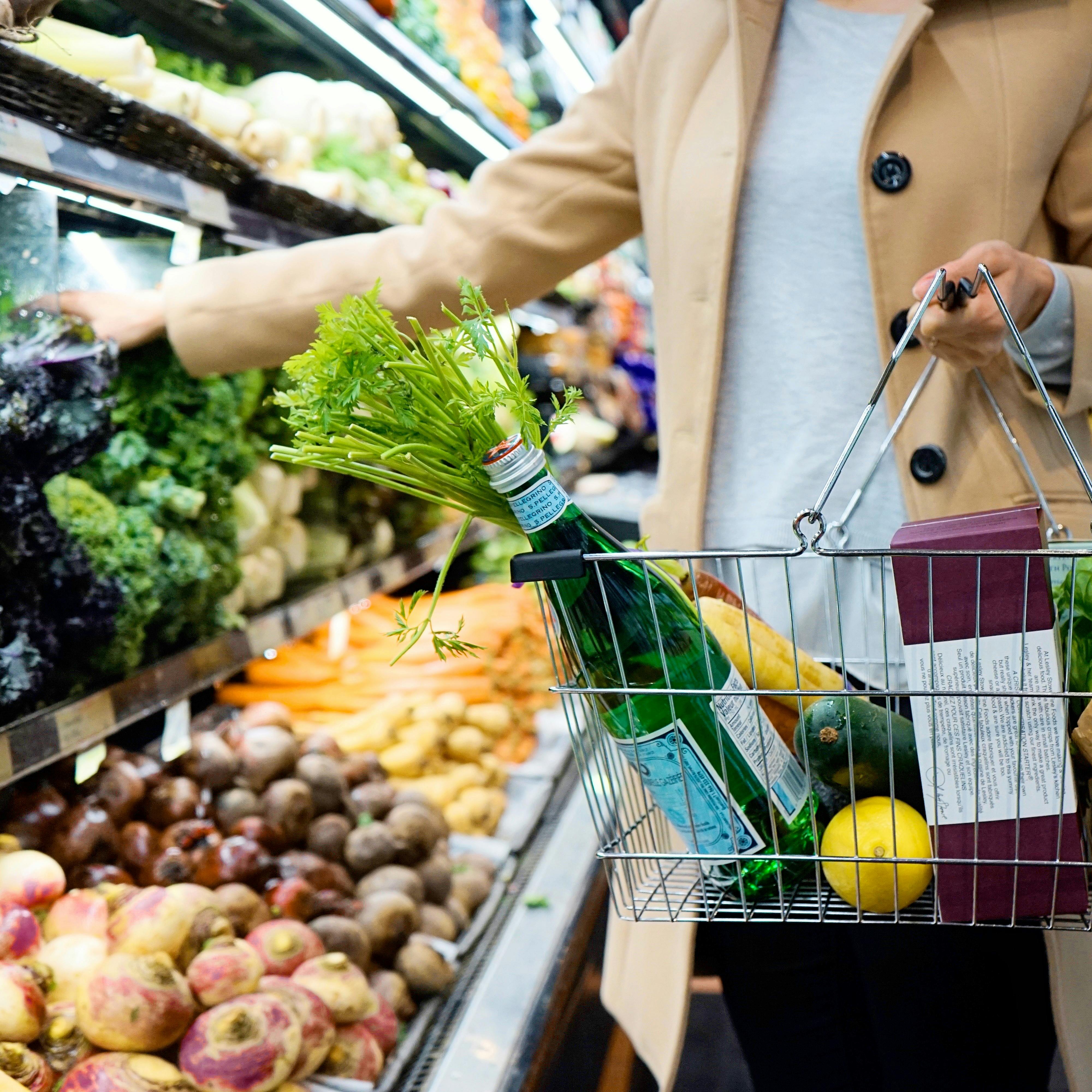Person shopping in produce section of grocery store
