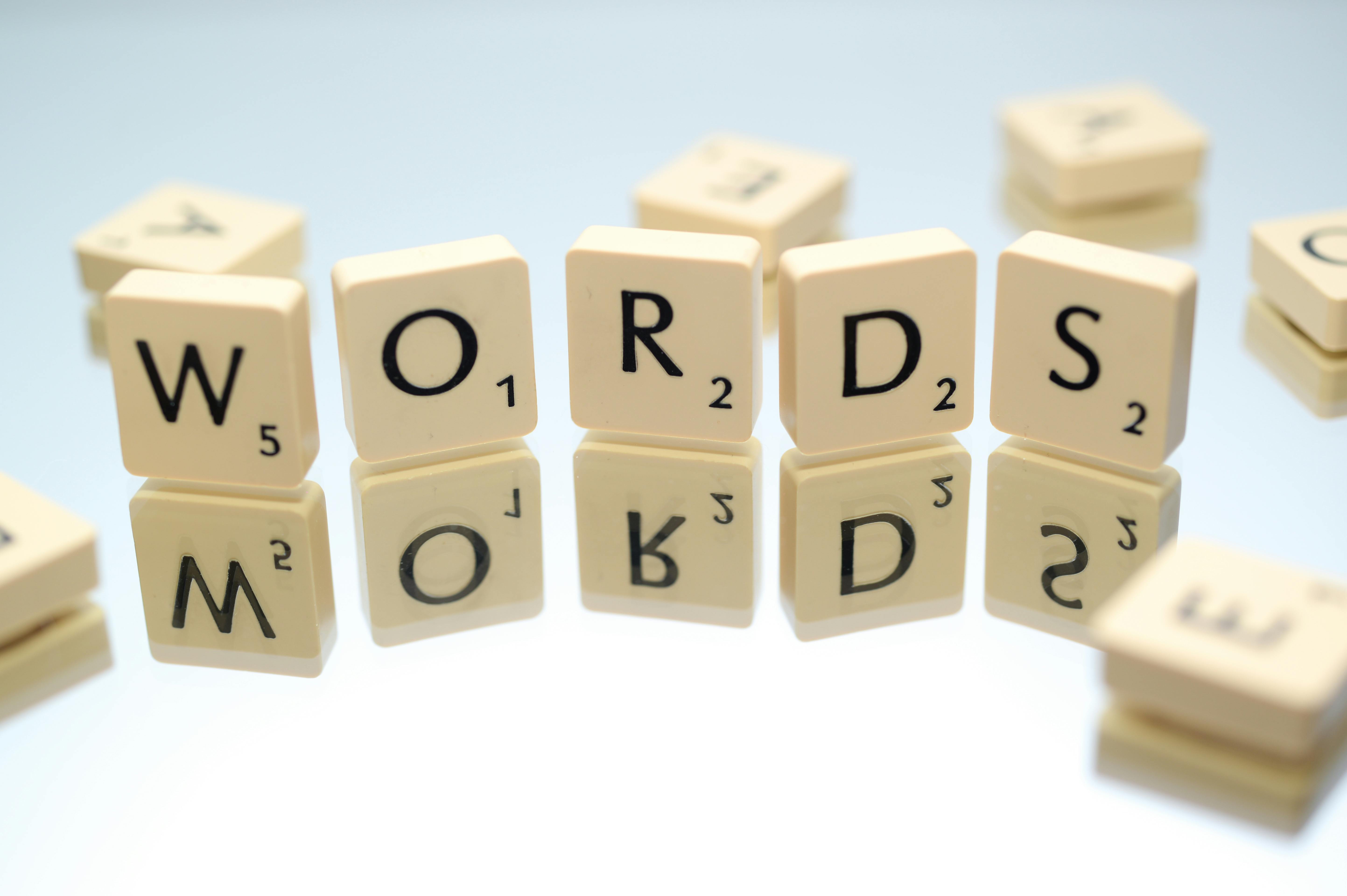 The word "words" spelled out with scrabble tiles