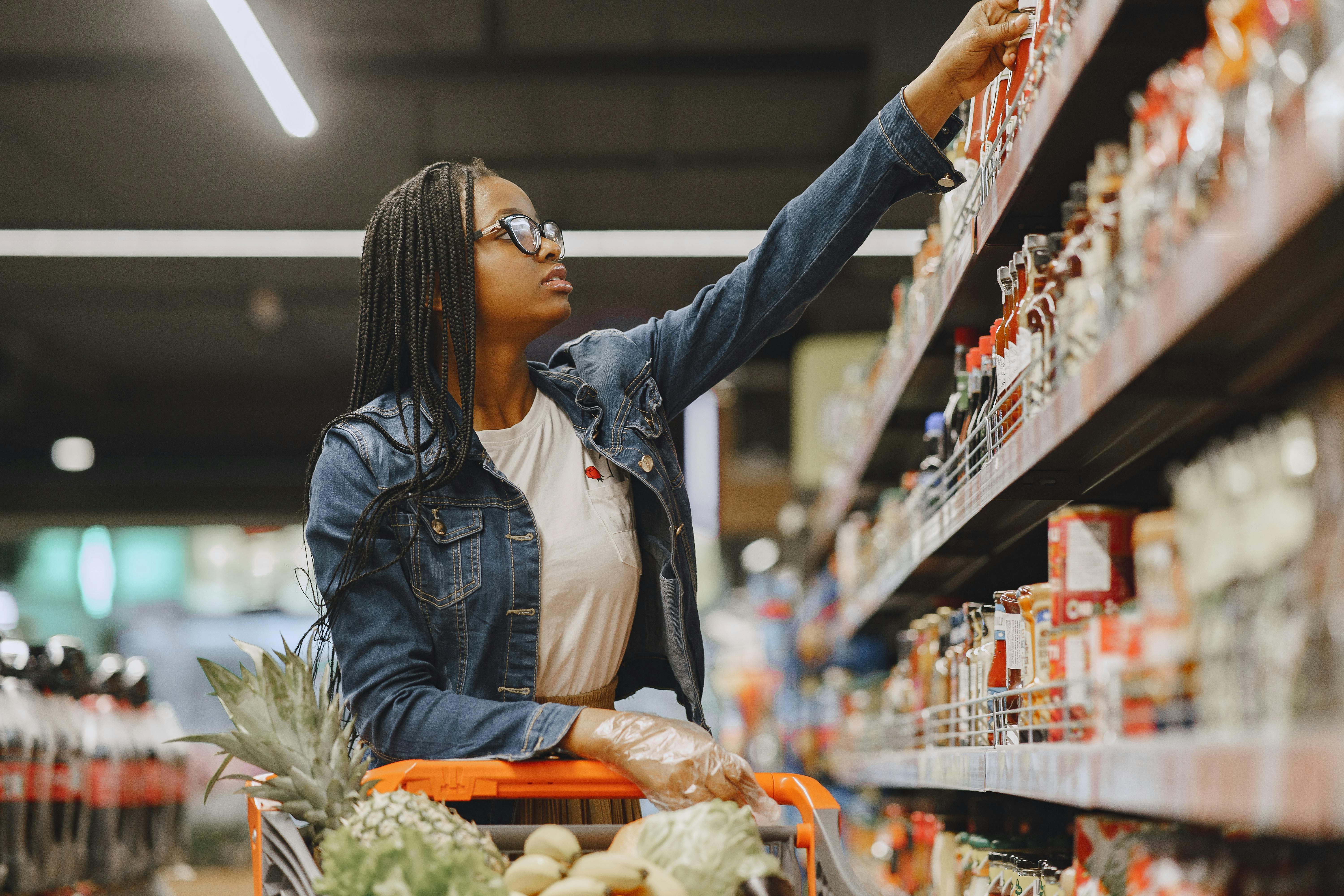 Woman with full cart shopping at grocery store