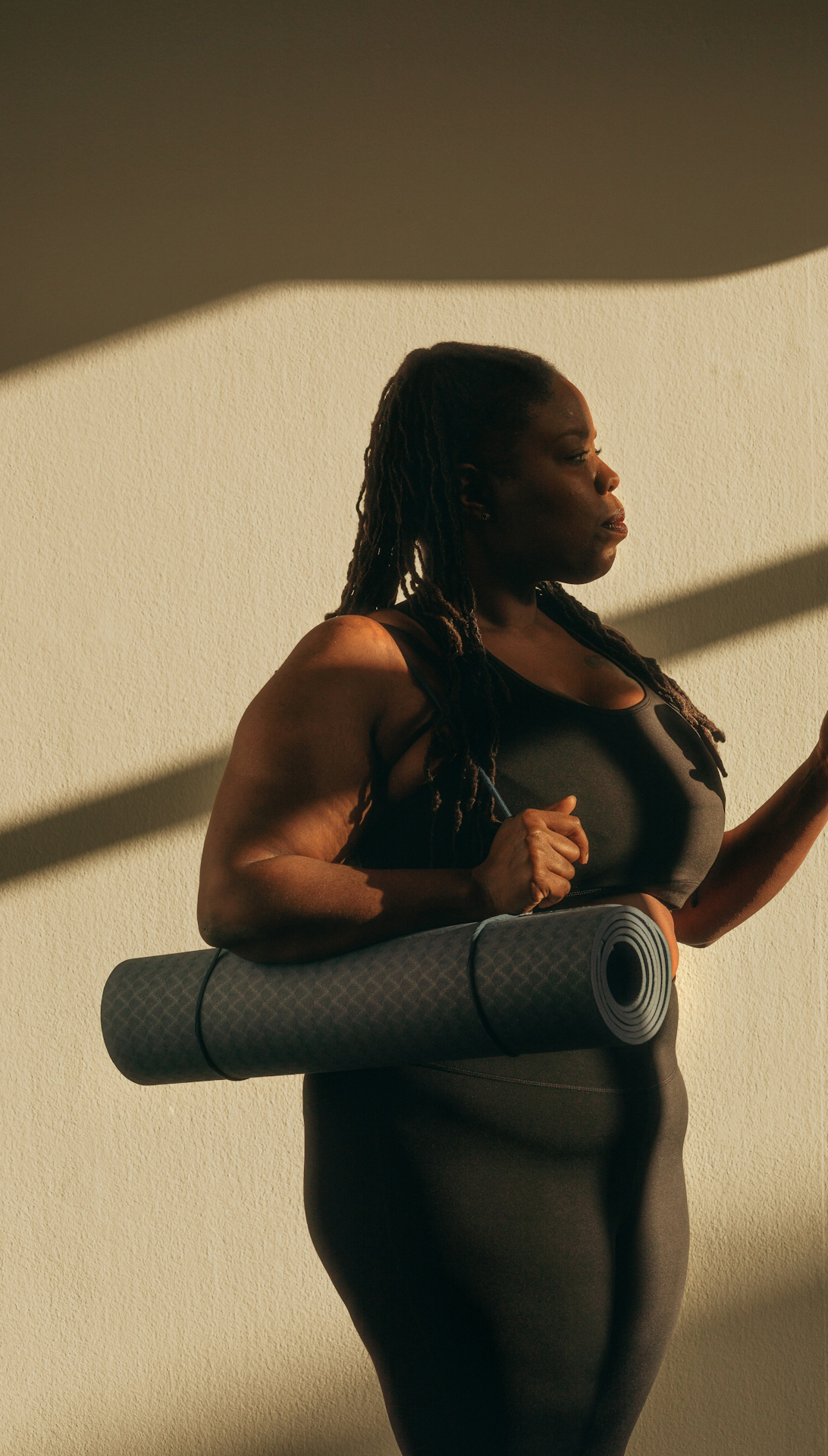 Woman carrying yoga mat