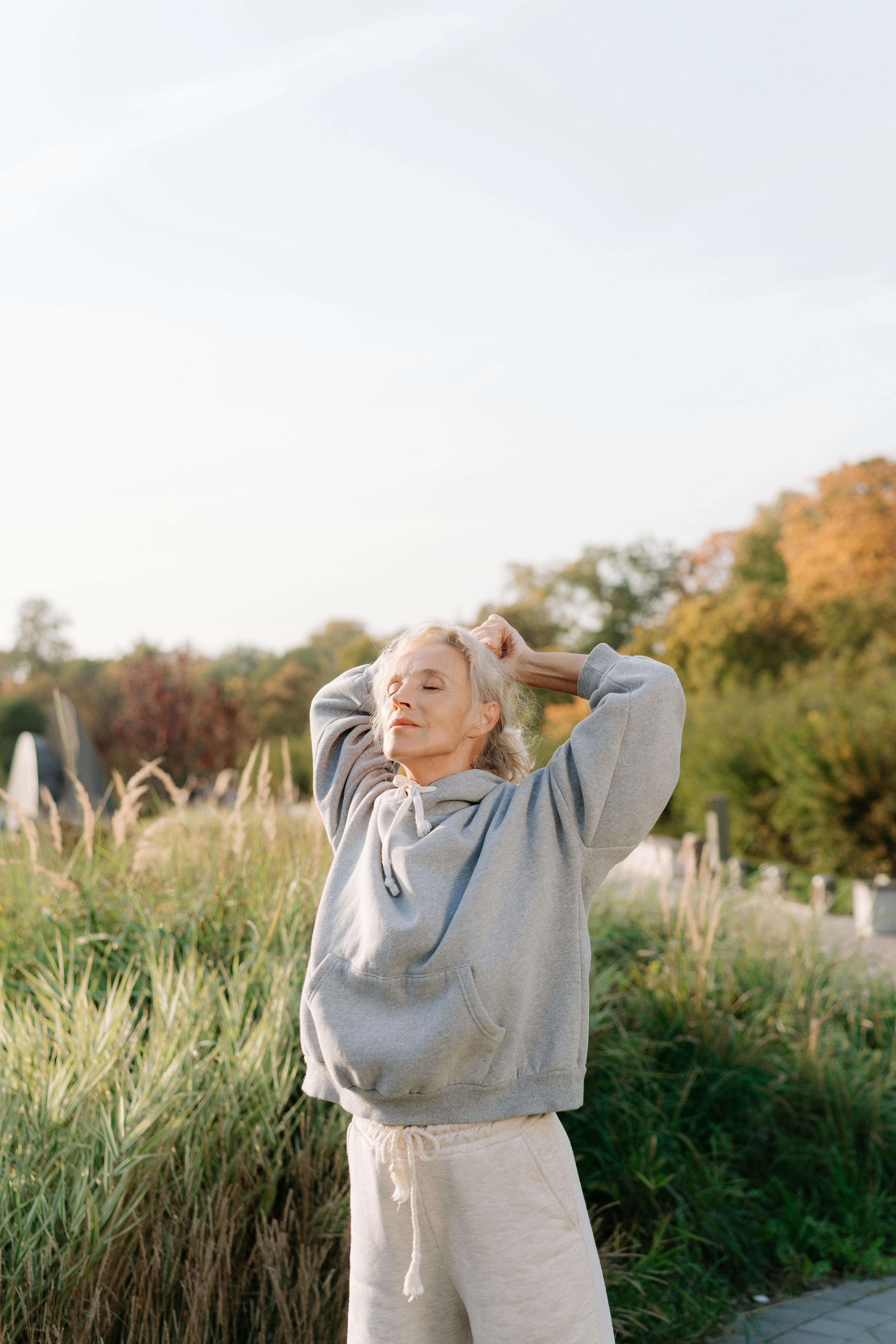 Woman stretching in a field